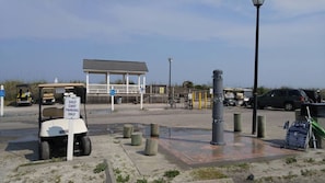 A golf cart parked in a designated area with a sign indicating 'GOLF CART PARKING ONLY'. - “Tiki time Getaway” dog friendly, Corner of splash pad and pool. Up to 6 guest. (surfside Beach)