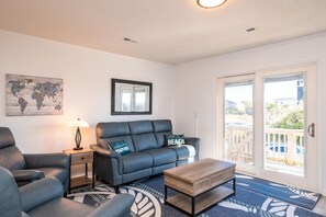 Relax in this stylish living room with a sofa, armchair, and wooden coffee table.