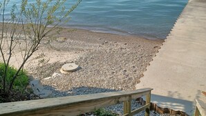 A wooden staircase leading to a pebbled beach with a view of the sea. - Lake Erie Cottage w/ Private Beach Access - Couples Retreat (Madison)