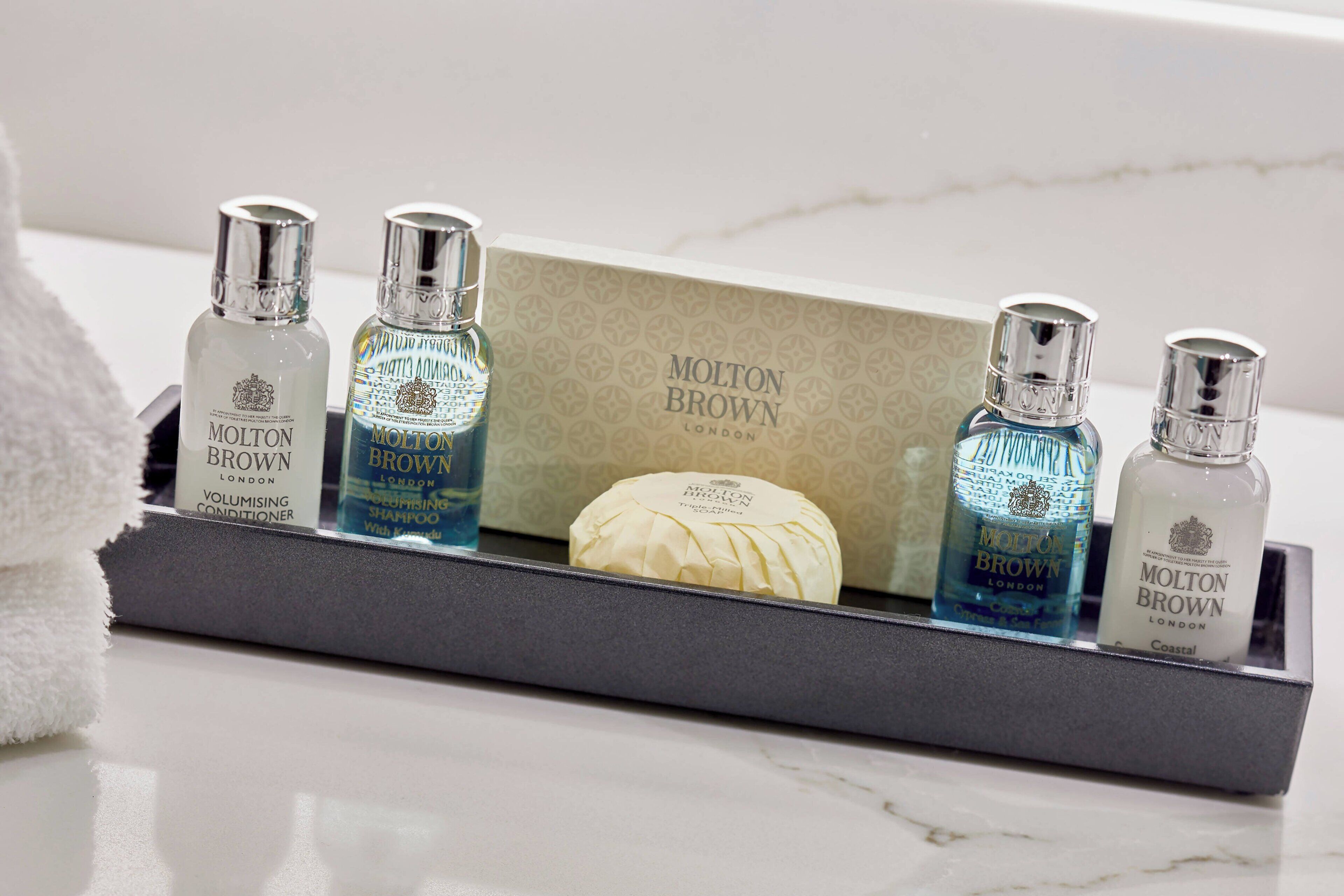 combined shower/bathtub, designer toiletries, hair dryer, towels