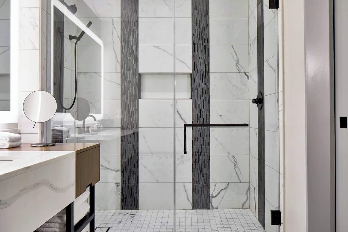 combined shower/bathtub, designer toiletries, hair dryer, towels