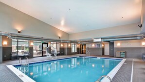 An indoor swimming pool with clear lane markings, a lifeguard chair, and a poolside area with chairs and a sunshade. - Residence Inn by Marriott Cleveland Airport/Middleburg Heights (Middleburg Heights)