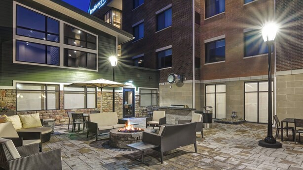 An outdoor patio with seating, a fire pit, and a bar area. - Residence Inn by Marriott Cleveland Airport/Middleburg Heights (Middleburg Heights)