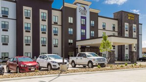 A Sleep Inn hotel with a modern design, featuring a parking lot with several cars. - Sleep Inn Logan Ohio-Hocking Hills (Logan)
