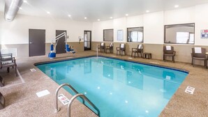 An indoor swimming pool with a clear water surface, a lifeguard chair, and a pool ladder. - Sleep Inn Logan Ohio-Hocking Hills (Logan)