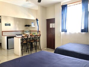 Grand Bungalow, Kitchen (2 Double and 1 Single Beds) | Minibar, blackout curtains, iron/ironing board, free wired Internet