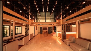A spacious lobby with a high ceiling, seating areas, and a view through large windows. - Anika Boutique Hotel (Chiang Mai)