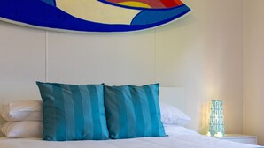 A neatly made bed with two teal pillows and a white comforter. - Eight On The Lake - Fairhaven Point Way 8 (WALLAGA LAKE)