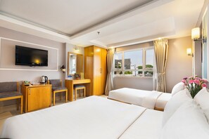 A hotel room with a bed, a desk, a TV, and a window with curtains. - Lucky Star Hotel 146 Nguyen Trai (Ho Chi Minh City)
