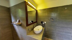 A modern bathroom with a large mirror, a sink, and a towel rack. - Ehalagala Lake Resort (Sigiriya)