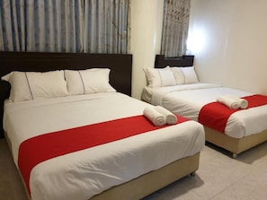 Two twin beds with white bedding and red accents, a dark headboard, and a window with curtains. - Fully Hotel Desa Tebrau (Johor Bahru)