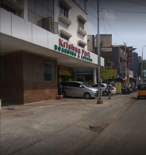 A building with a sign for 'Krishna Park Boarding & Lodging'.