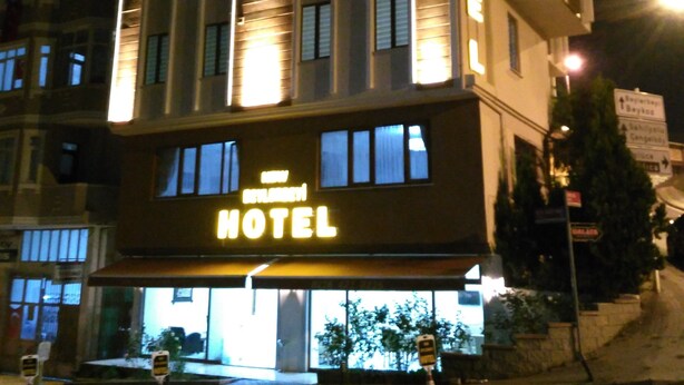 A hotel with a modern facade, illuminated signage, and a visible entrance. - New Beylerbeyi Hotel (Istanbul)