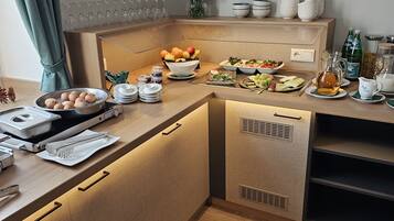 A modern kitchen with a wooden countertop, a built-in oven, and various kitchen utensils.