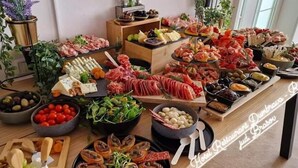 A buffet table with various food items including meats, cheeses, and vegetables. - Hotel-Restaurant Dumbrava Rupea (Rupea)