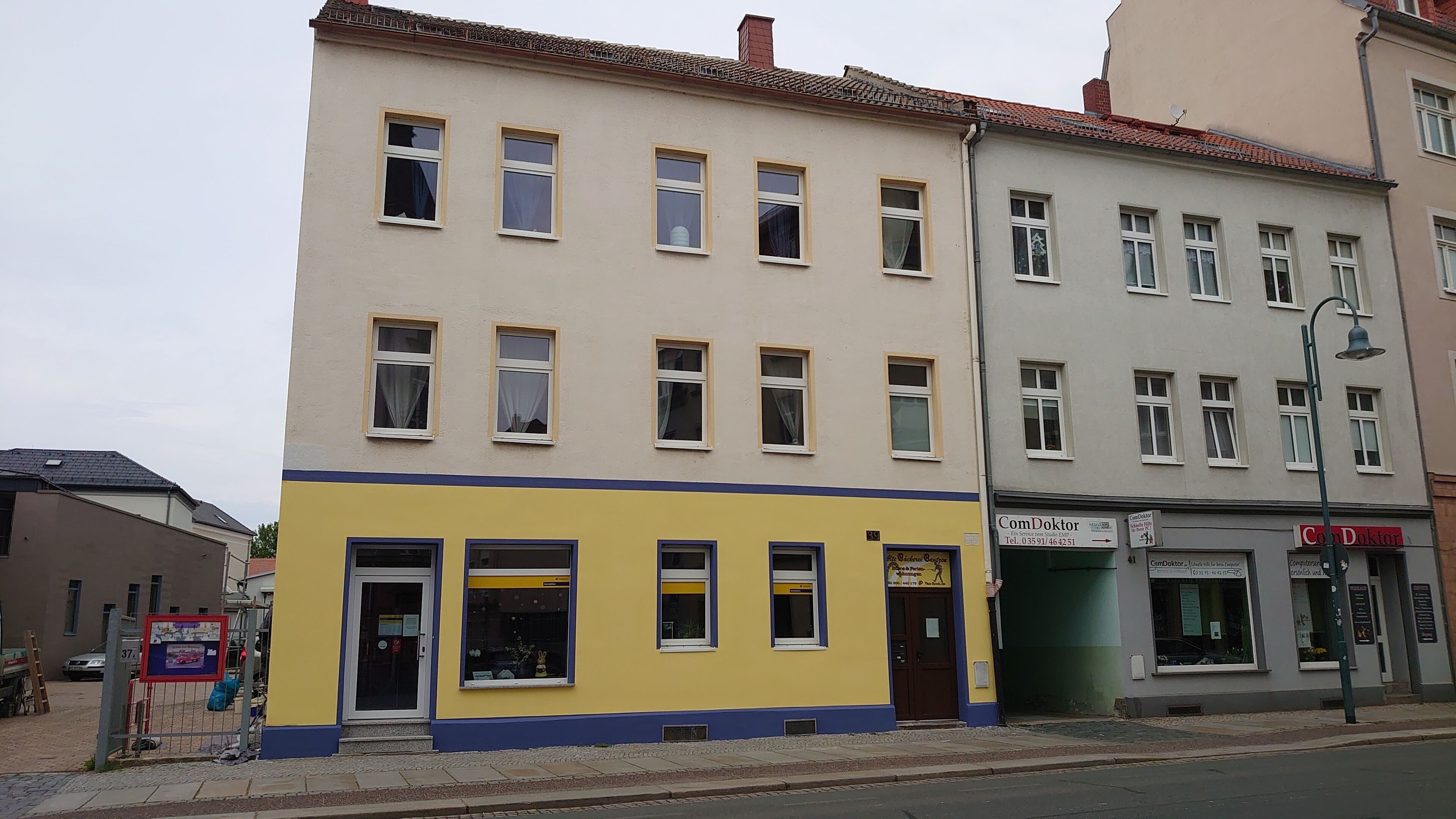 A multi-story building with a ground-floor storefront and a medical office on the second floor.