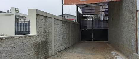 A gated entrance to a building with a sign advertising Omah59 services.