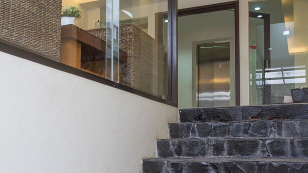 A staircase with stone steps leading to a higher floor. - RedDoorz @ Malabar Street (Bandung)