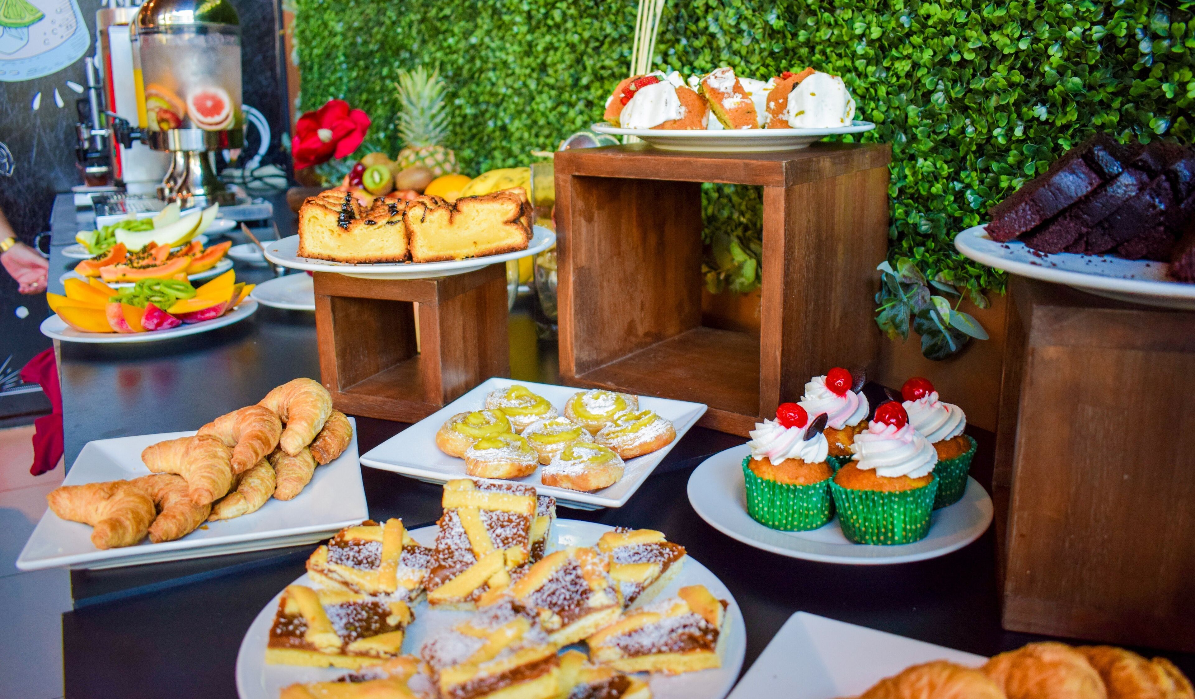 A buffet table with various pastries and desserts.