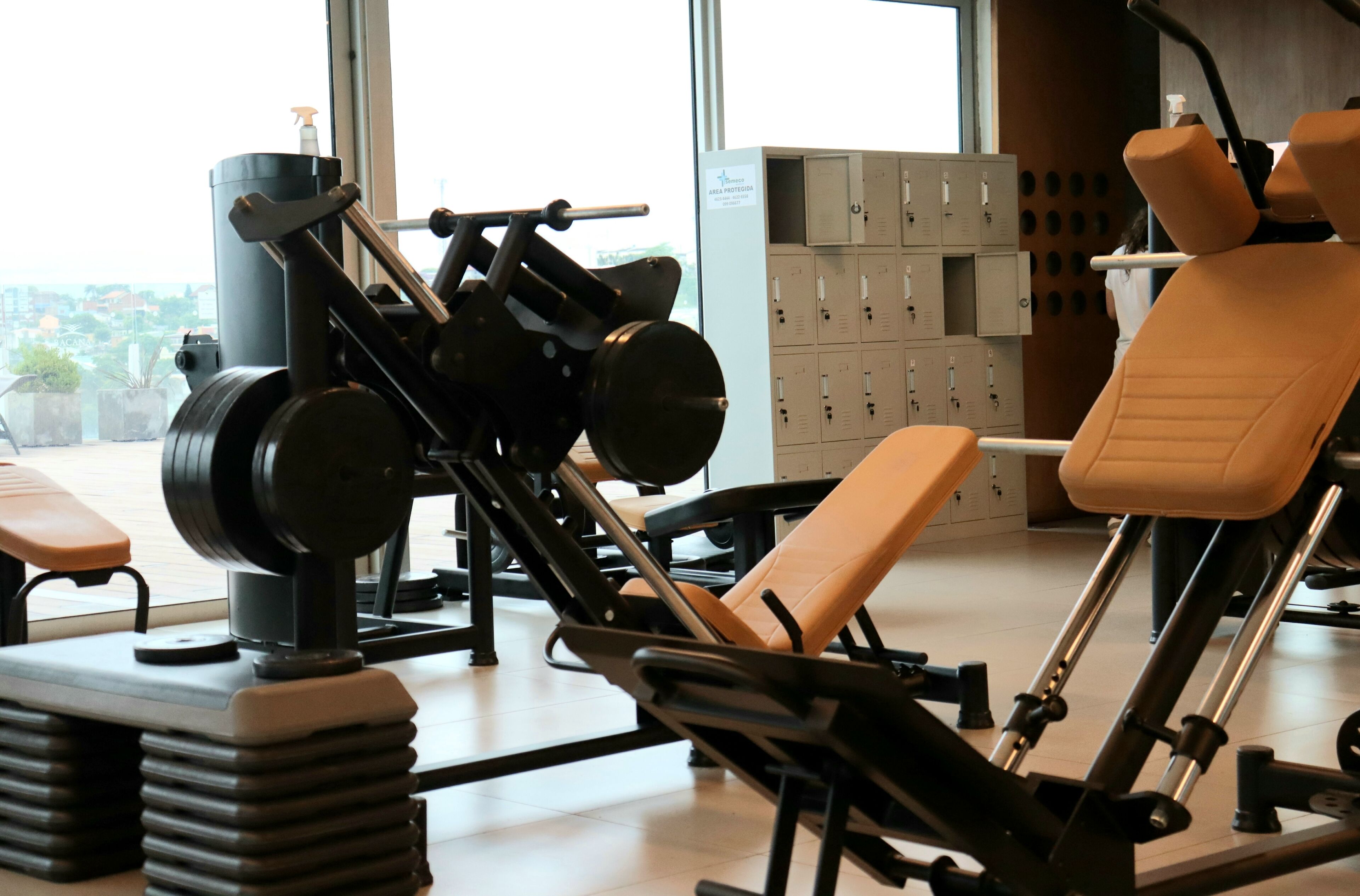 A gym with exercise equipment, benches, and lockers.