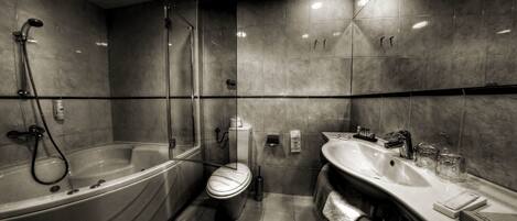 A modern bathroom with a freestanding bathtub, a toilet, and a double sink vanity.