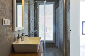 Villa | Bathroom | Shower, hair dryer, slippers, towels
