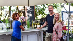A wine tasting event with a bar counter displaying various wine bottles and glasses. - Sydkustens at Pillehill (Skivarp)
