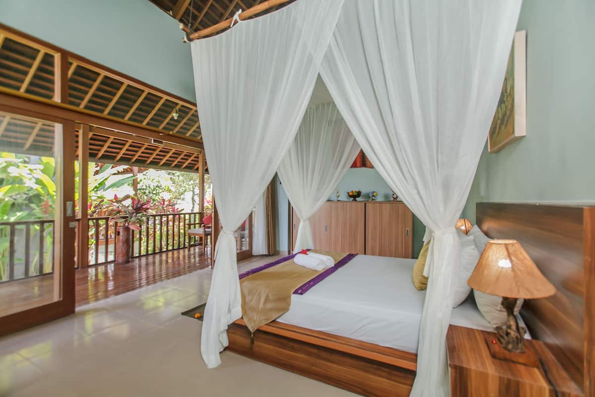 A room with a bed, a nightstand, a lamp, a wooden headboard, a wooden bench, a wooden door, a wooden ceiling, a wooden floor, a white curtain, a wooden cabinet, a wooden railing, a wooden table, a wooden chair, a wooden shelf, a wooden picture frame, a wooden plant pot, a wooden plant, a wooden plant stand, a wooden plant, a wooden plant pot, a wooden plant pot, a wooden plant pot, a wooden plant pot, a wooden plant pot, a wooden plant pot, a wooden plant pot, a wooden plant pot, a wooden plant pot, a wooden plant pot, a wooden plant pot, a wooden plant pot, a wooden plant pot, a wooden plant pot, a wooden plant pot, a wooden plant pot, a wooden plant pot, a wooden plant pot, a wooden plant pot, a wooden plant pot, a wooden plant pot, a wooden plant pot, a wooden plant pot, a