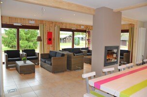 Chalet Confort, varias habitaciones | Zona de estar | Una televisión de pantalla plana, una chimenea, un reproductor de DVD