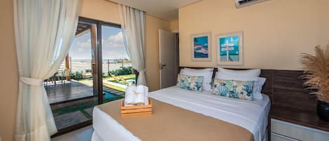 A hotel room with a bed, a nightstand, a window with curtains, and a view of the outdoors.