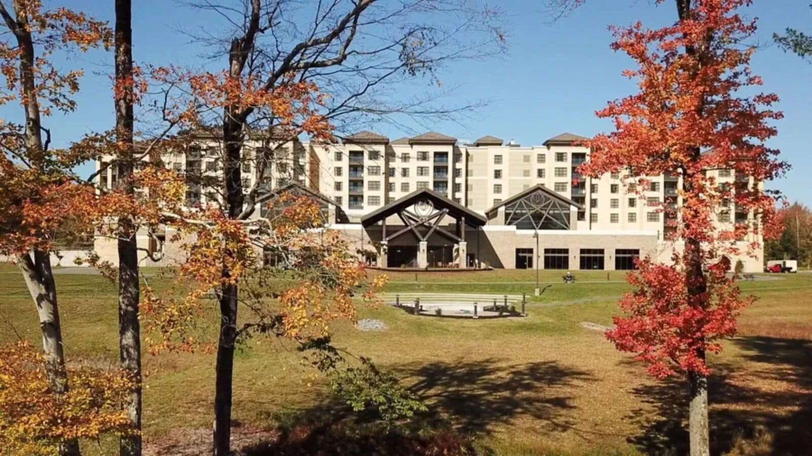 A multi-story building with a central atrium and a large outdoor seating area.
