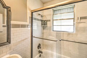 A glass-enclosed shower with a window, white tiled walls, and a handrail. - Lakeview Home - 1 Mile from Bull Shoals Lake! (Lakeview)