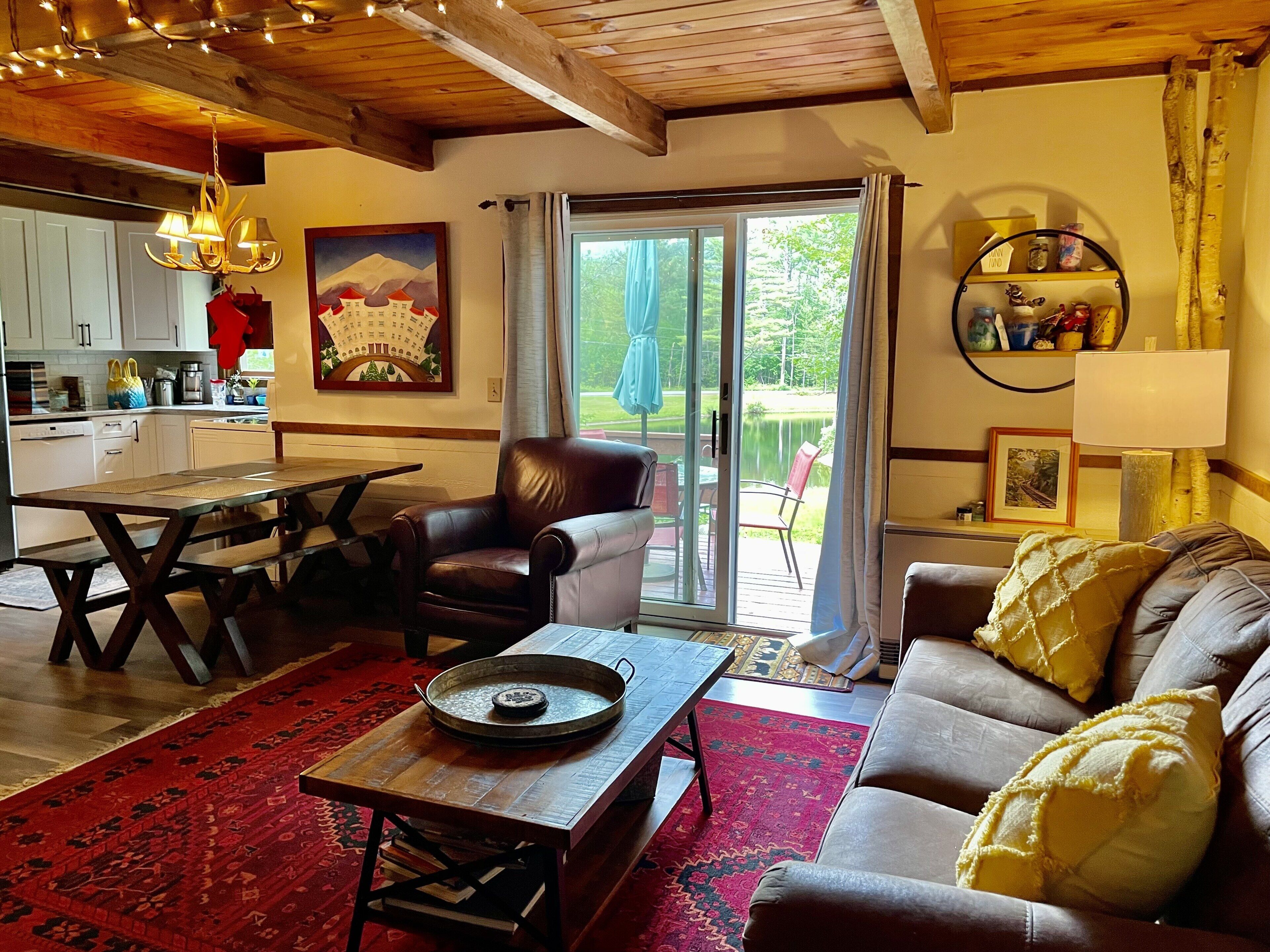 Living room features rustic floors, decor, and a wood burning stove