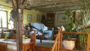 A rustic room with a wooden chair, a bed with a blue cover, a wooden table, and a potted plant. - Country Cottage + Fabulous Views. PRIVATE Exclusive Pool.  WIFI.  Pets Welcome! (Ayen)