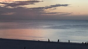 A beach at sunset with calm waters and a few people in the distance. - Newly remodeled beach front! SPECIAL RATE SEPTEMBER and OCTOBER (Marco Island)