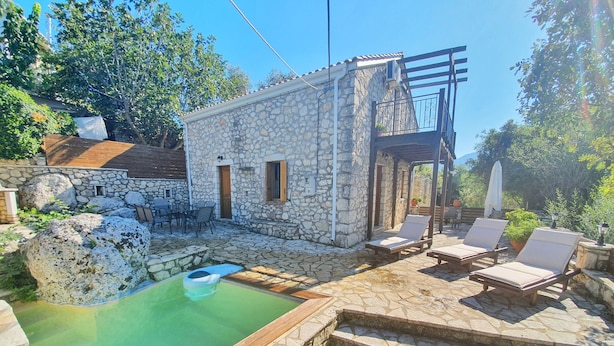 A stone building with a pool, outdoor seating, and a pergola. - Villa Kalata (Lefkada)