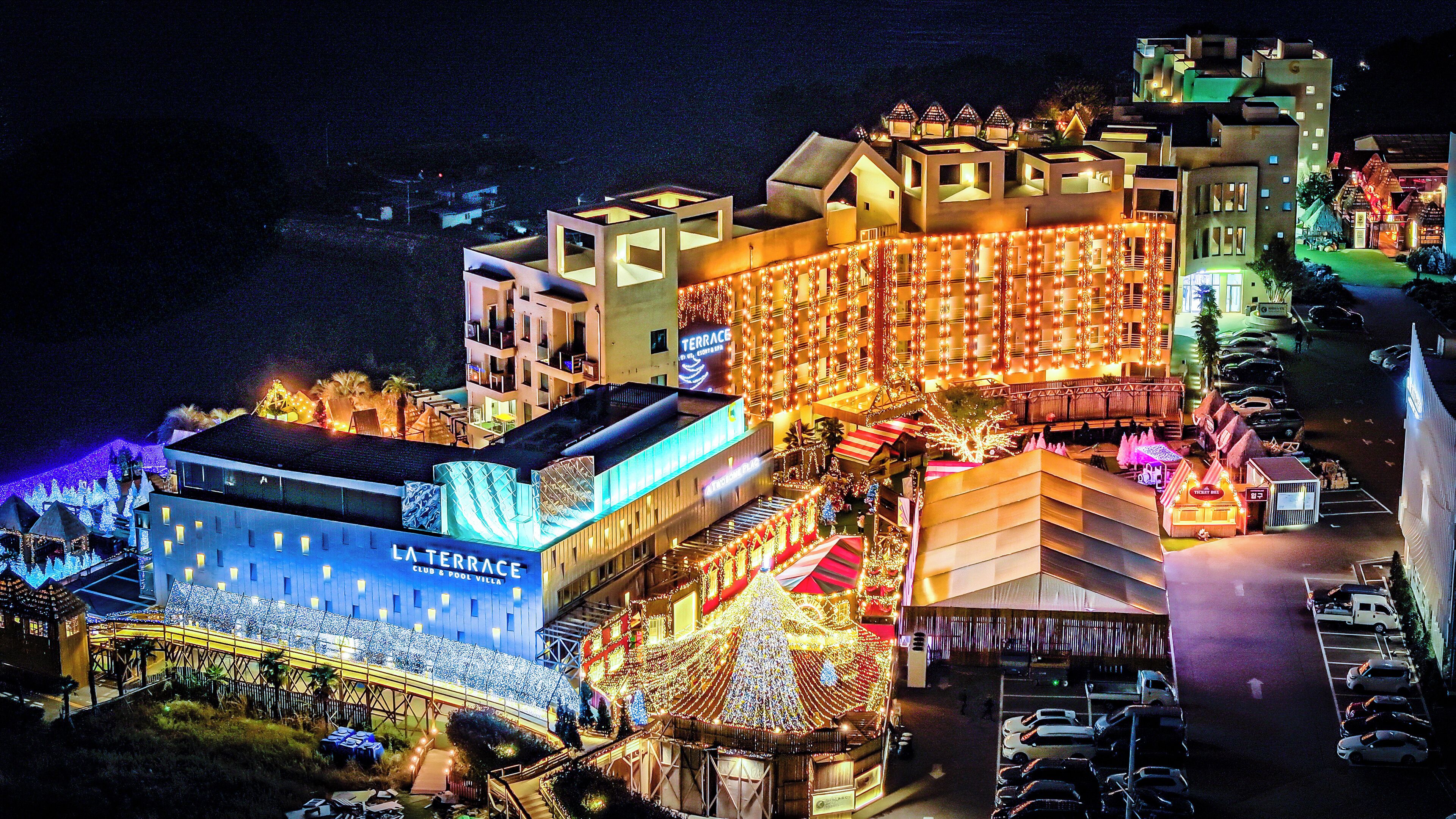 A hotel with multiple buildings, including a terrace and pool villa.