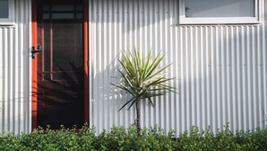 A building with a red door and a window. - The Station Master's House, A darling house with everything you need for a relaxing getaway in Castl... (Castlemaine)
