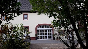 Ein Gebäude mit heller Fassade, einem großen Rundbogenportal und einem Schild mit der Aufschrift 'Blue'.