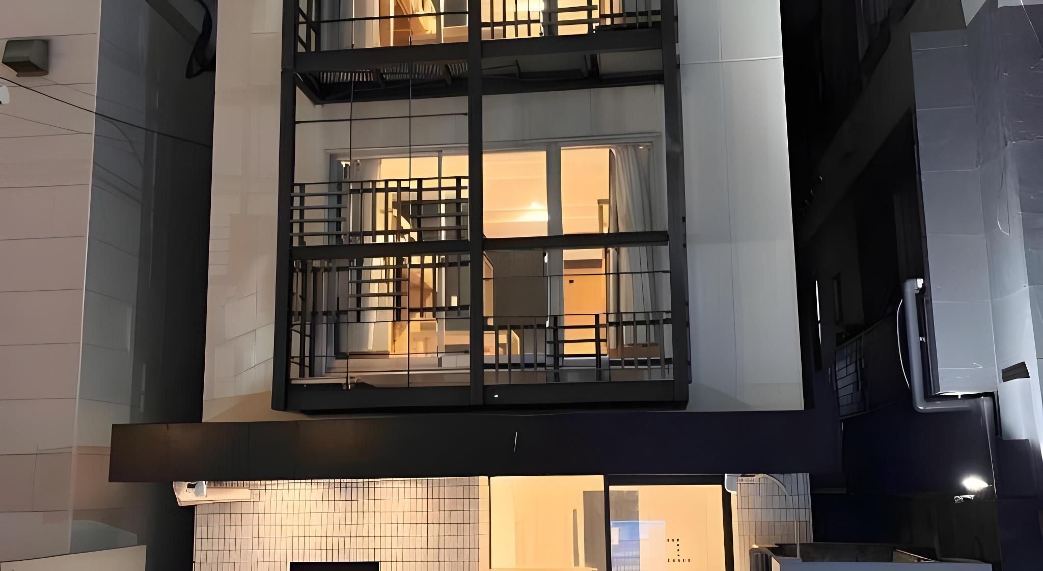 A multi-story building with a balcony on the second floor.