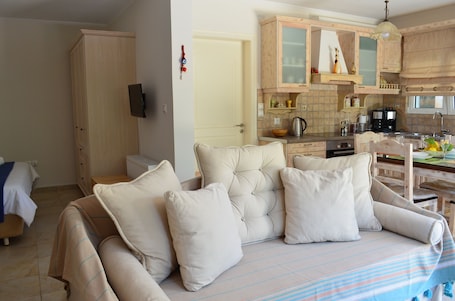 Romantic Studio, Garden View | Living room | Flat-screen TV, DVD player