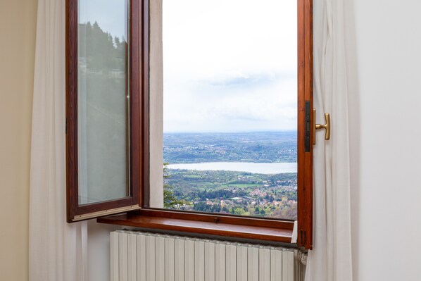 A window with a view of a lake and a town. - Albergo Sacro Monte Varese (Varese)