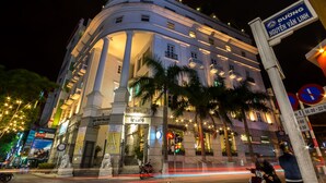 A historic building with classical architecture, featuring columns and a statue. - Danang Boutique Hotel (Da Nang)