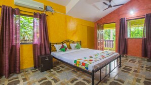 A room with a bed, air conditioning unit, ceiling fan, and patterned floor. - OYO 19876 Home Classic 2BHK Near Carmona Beach (Varca)