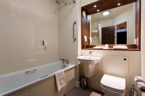 A bathroom with a bathtub, sink, and toilet. - Sweet Chestnut, Dunfermline by Marston's Inns (Dunfermline)