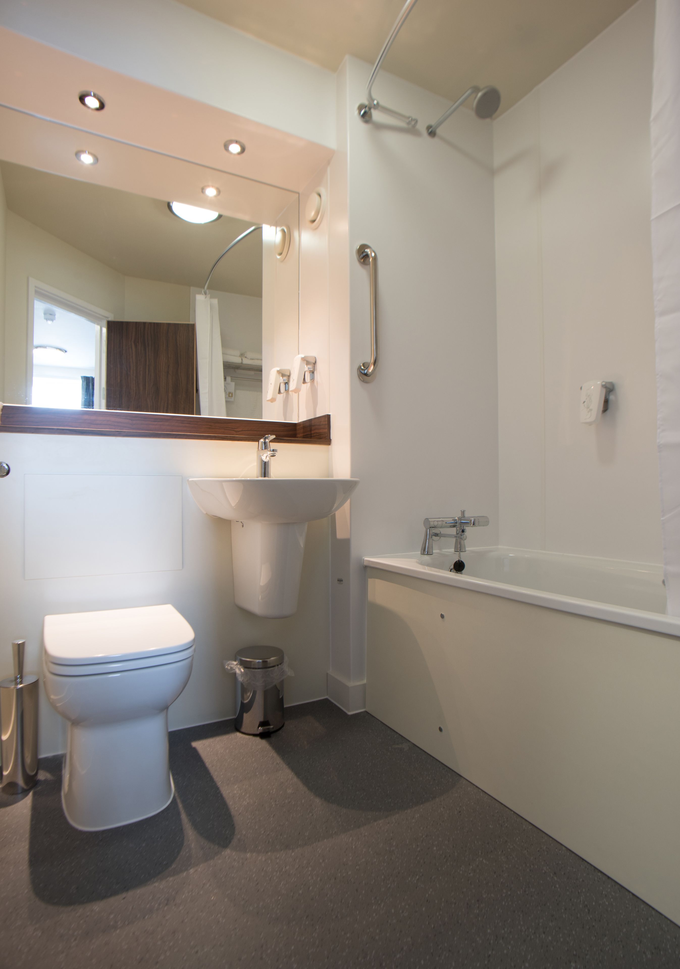 A modern bathroom with a toilet, sink, and bathtub.