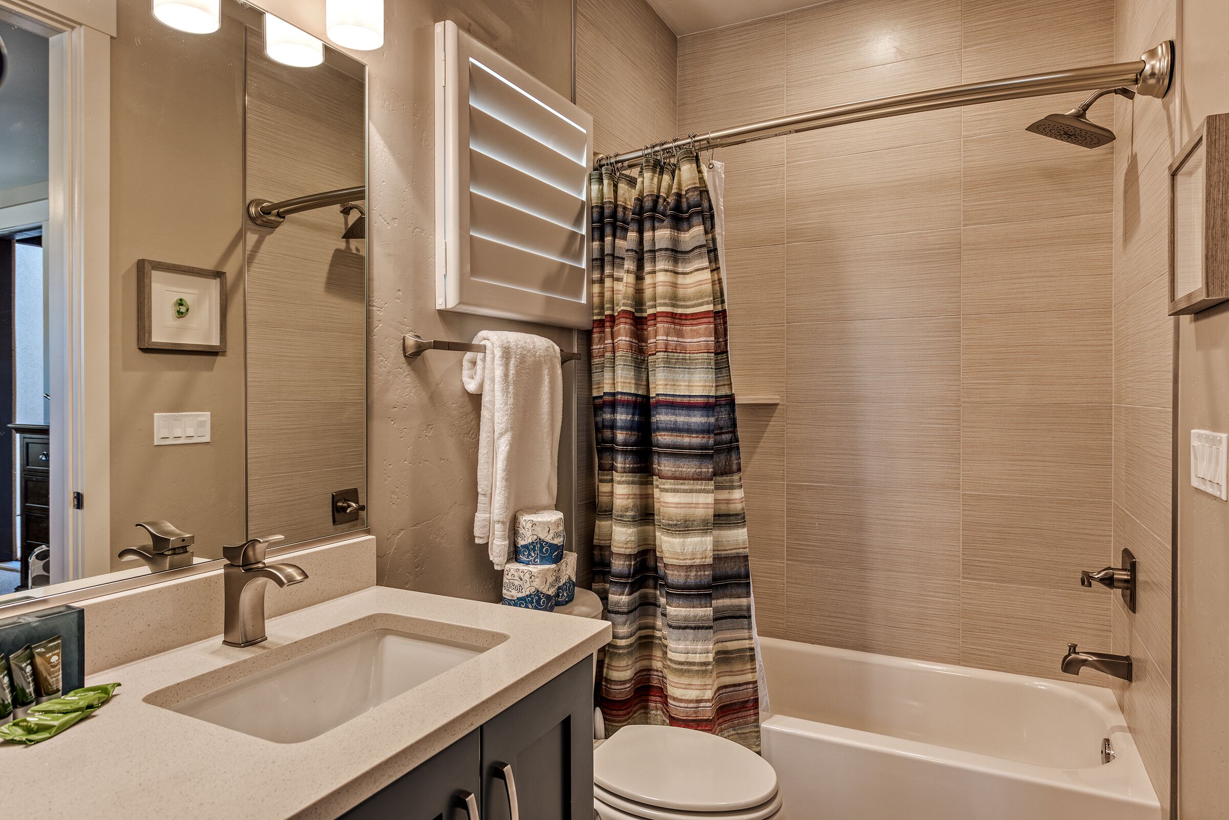 A bathroom with a sink, toilet, and bathtub.