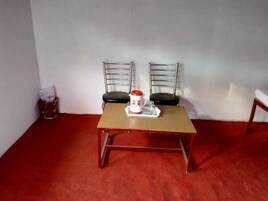 A small dining area with a table and two chairs.
