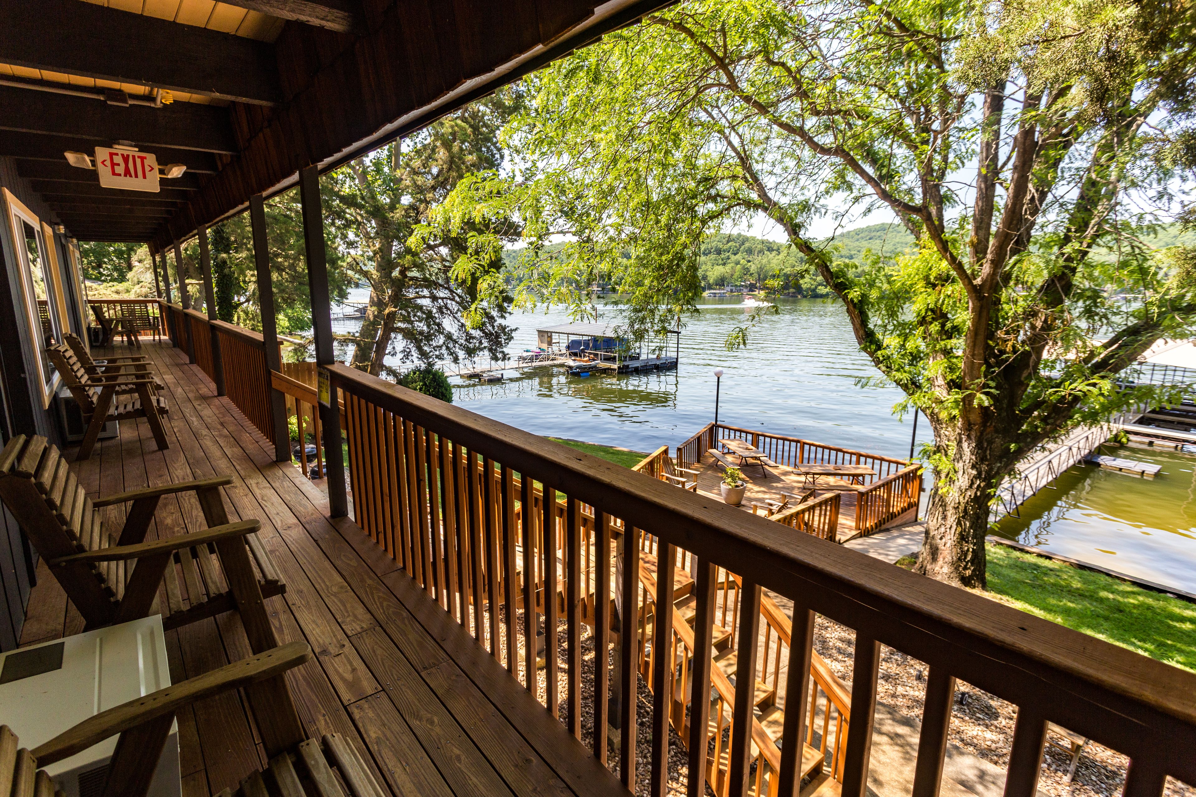 Ein Holzdeck mit Blick auf einen See und eine Anlegestelle.