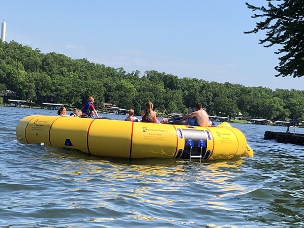 A yellow inflatable raft on water with people on it.